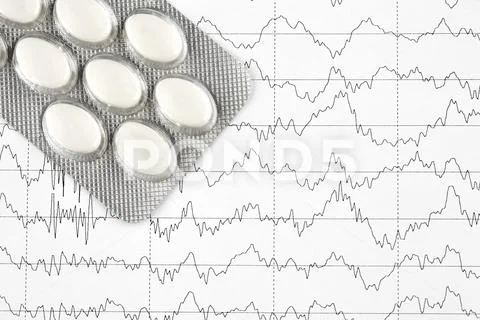 Close-up photo of blister with white pills on EKG graph Stock Photos