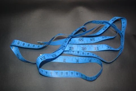 Close up photo of blue sewing meter isolated on black background Stock Photos