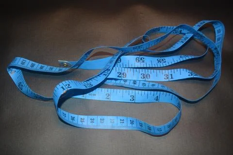Close up photo of blue sewing meter isolated on black background Stock Photos