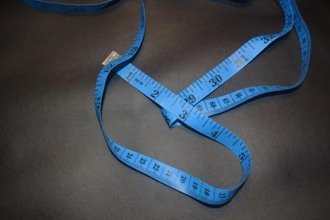 Close up photo of blue sewing meter isolated on black background Stock Photos