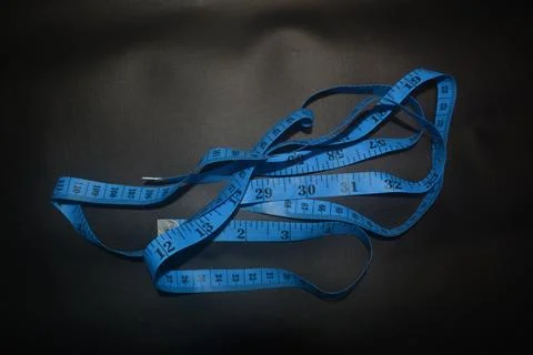 Close up photo of blue sewing meter isolated on black background Stock Photos