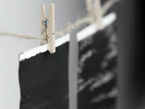 Close-up of photo frames hanging on the rope with wooden pins. Stock Photos