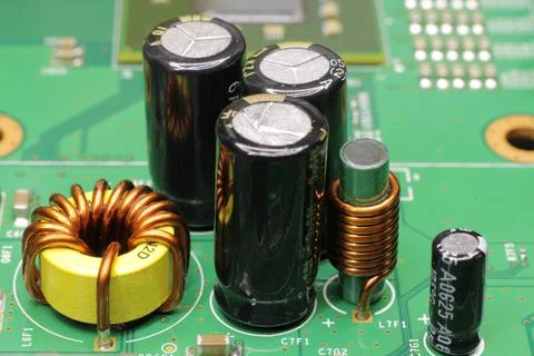 The close-up photo of a group of electrical components on a motherboard. Stock Photos
