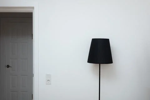 Close-up photo of A hand changes a light bulb in a stylish loft lamp from the Stock Photos