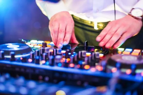 Close up photo of hands of dj playing music at console Stock Photos