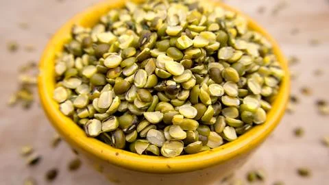Close-Up Photo of Split Mung Beans (Green Gram) Isolated in a Yellow Bowl Stock Photos