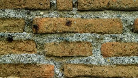 Close up photo of the texture of an old weathered brick wall. Macro photo b.. Stock Photos