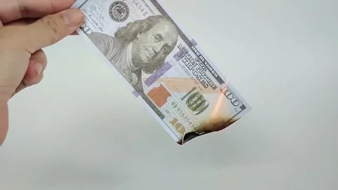 Close-up photo of a US one hundred dollar bill burning Stock Footage 325468038