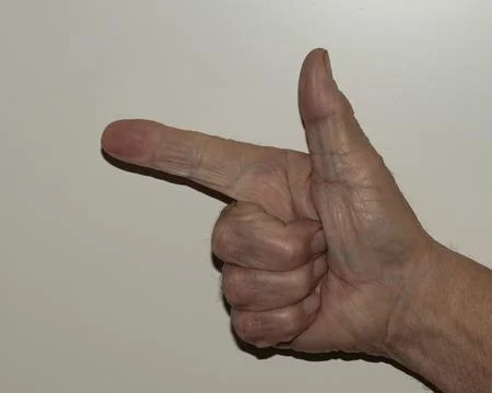 Close-up photograph capturing an elderly hand displaying the number two wit.. Stock Photos