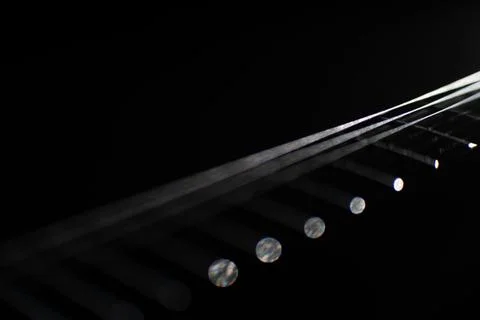 Close-up photograph of linear, reflective objects in a black background wit.. Stock Photos