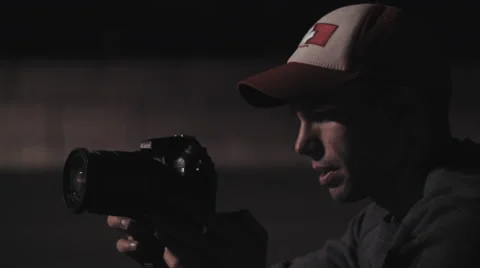 Close up of Photographer adjusting camera at night Stock Footage 60267955