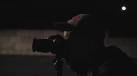 Close up of Photographer using camera at night Stock Footage 60267915