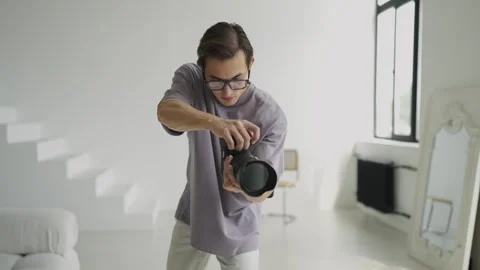 Close-up photographer working with model in studio with natural light. Backstage Stock Footage 243222454