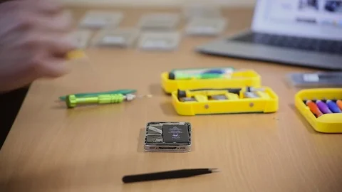 Close-up photos showing process of mobile phone repair, changing the screen Видео 70139434