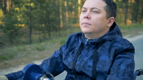 Close up of a physically challenged man's face while pushing wheelchair's handle 動画素材 90758041