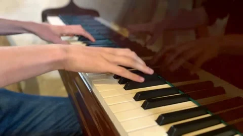 Close up of pianist student hands practicing and playing brown wooden piano Stock Footage 337264090