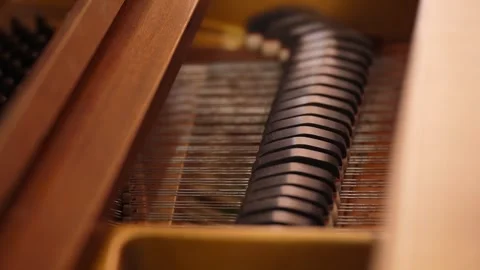 Close up of piano hammers and strings inside upright piano 库存影片 347813737