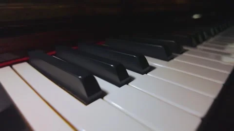 Close Up Piano Keys with Reflections and Flickering Light Stock Footage 345089528