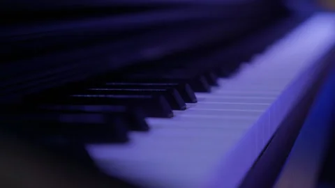 Close-up of piano keys on stage. Colored blue lights Stock Footage 319480087
