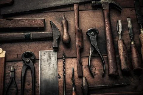 Close up pic of rusty old carpentry tools on wooden workbench Stock Photos