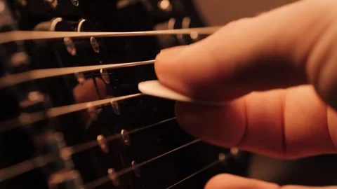 A close-up of a pick on an electric guitar strings Stock Footage 305269371