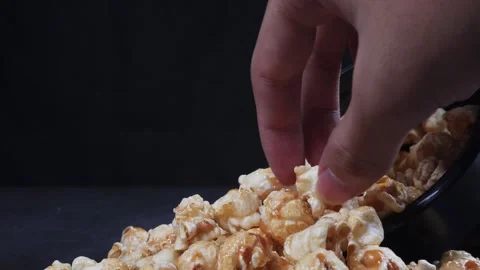 Close up of picking up spilled popcorn by hand 库存影片 279701338