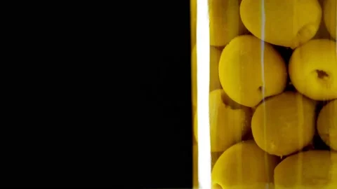 Close-up, pickled large green olives in a glass jar, food product rotate on Stock Footage 131062428