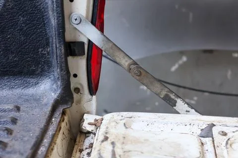 Close-up of a pickup truck's tailgate support arm Stock Photos