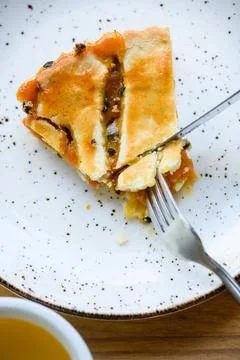 Close-up of a pie and a fork with a knife. Stock Photos
