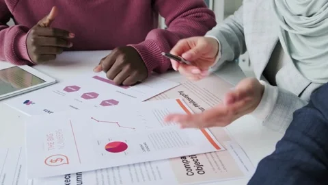 Close up of a pie chart and hands. International team working on statistical Stock-Footage 334653903