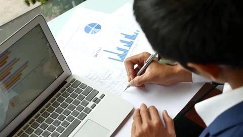Close up of a pie chart and hands. International team working on statistical Stock-Footage 334654418