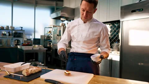 Close-up of a piece of baguette on the table on white board burning bread with a Stock Footage 273516215
