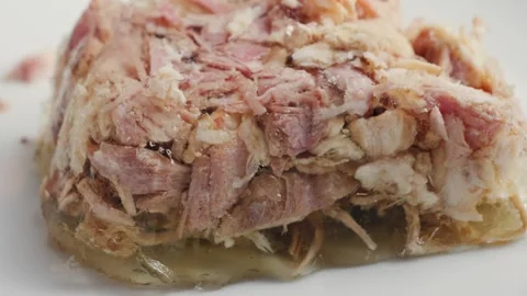 Close up of a piece of beef aspic on a plate. Pulled pork texture. Prepared Stock Footage 315229942