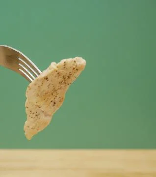 Close up piece of chicken on fork Stock Photos
