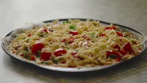 Close-up, pieces of cheese fall on the dough with tomatoes for pizza Margherita Stock Footage 172719915
