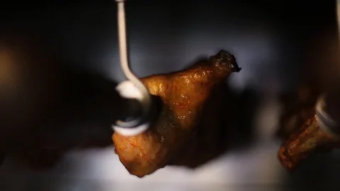 Close-up of pieces of chicken grilling in kitchen of prestigious restaurant of Stock-Footage 98560375