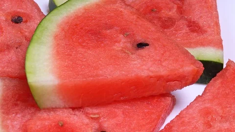 Close up. pieces of watermelon rotate in a circle on a white background Stock Footage 114188597