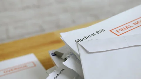 Close up of a pile of bills and letters with a medical bill final notice Stock Footage 220415971