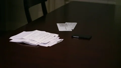 Close up of a pile of bills on a kitchen table Video stock 70712377