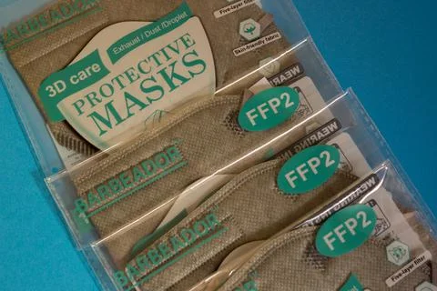 Close up of pile certified protective face ffp2 masks of grey color with thei Foto stock