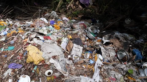 Close up of pile of clothes and garbage in forest,Trunyan, Bali, Indonesia Stock Footage 140268761