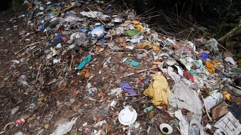 Close up of pile of clothes and garbage in forest,Trunyan, Bali, Indonesia Stock Footage 140268904