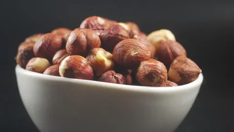 Close up of pile of delicious hazelnuts in white bowl, food and drink backg.. Stock Footage 333032455