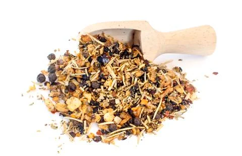 Close-up of pile of dried vegetables and herbs in a wooden spoon on white bac Stock Photos