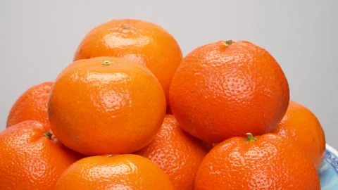 Close-up Pile of Ripe Oranges Rotating on White Background Studio Shot 4K Stock Footage 319428165