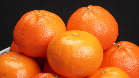 Close-up Pile of Ripe Oranges Rotating on Black Background Studio Shot 4K Stock Footage 319436436