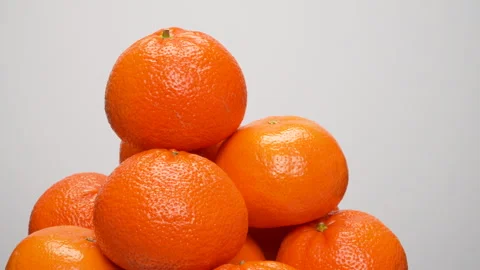 Close-up Pile of Ripe Oranges Rotating on White Background Studio Shot 4K Stock Footage 319453974