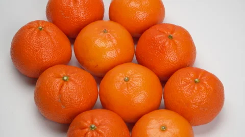 Close-up Pile of Ripe Oranges Rotating on White Background Studio Shot 4K Stock Footage 319454021