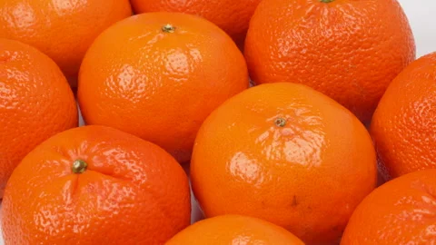 Close-up Pile of Ripe Oranges Rotating on White Background Studio Shot 4K Stock Footage 319454022