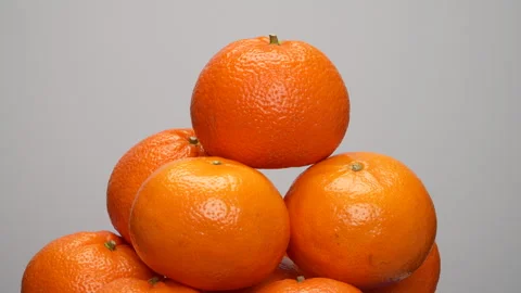 Close-up Pile of Ripe Oranges Rotating on White Background Studio Shot 4K Stock Footage 319454132